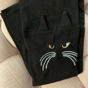 Leggings with cat faces on the knees